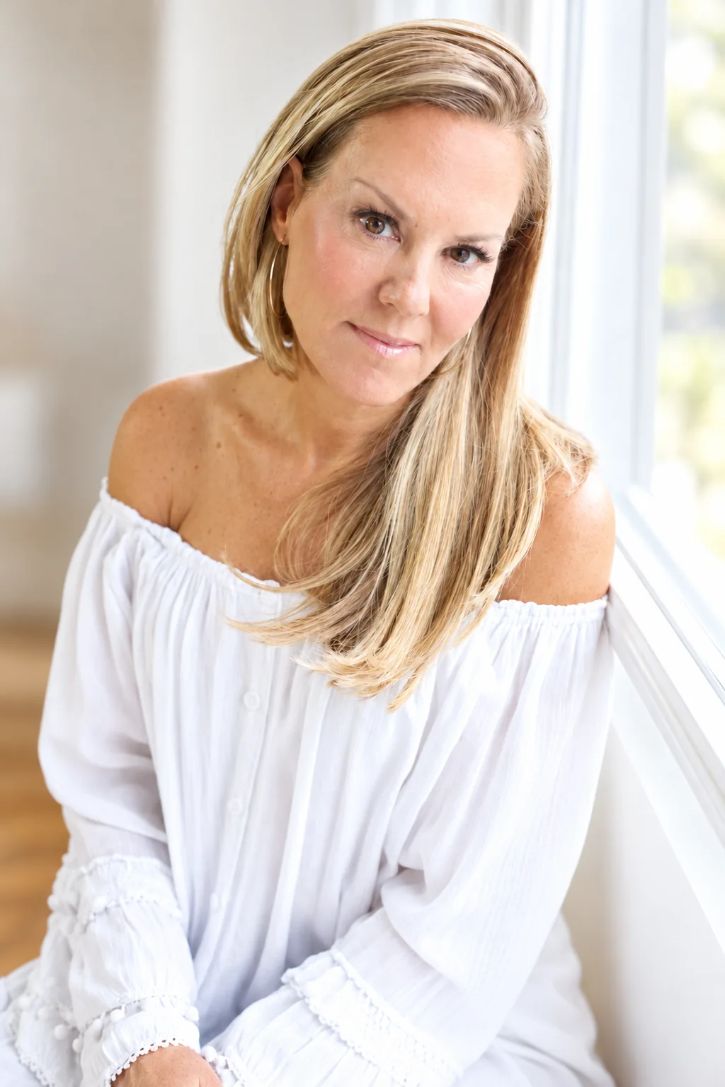 Lynne Goldberg seated by a window
